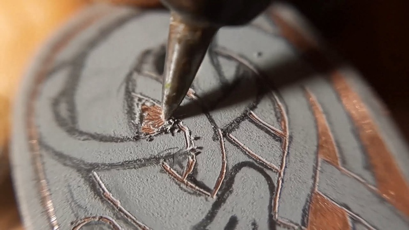 Drawing on metal. Damascus steel knife