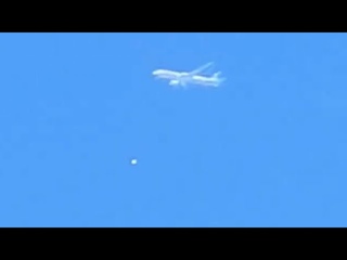 Sphere UFO passing by a plane in the Polish sky